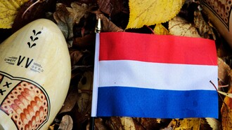 The flag of the Netherlands along with its iconic cultural footwear the clog