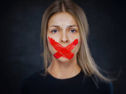 Depicting censorship, a young woman with adhesive tape over her mouth serves as a stark reminder of the critical need to safeguard freedom of expression and the press