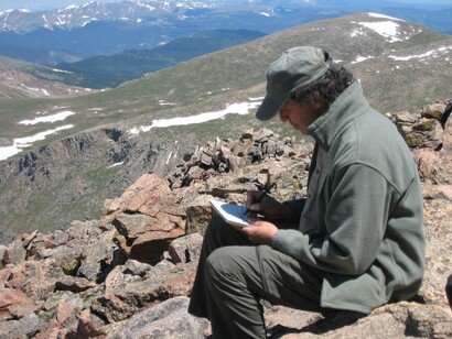 Lorenzo Chavez Sketching on top of Mt Bierstadt. Courtesy of Abend Gallery