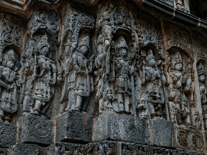 Finely chiselled stone deities and patterns in Shri Hoysaleswara Temple, Karnataka, reflecting the connection between art and worship