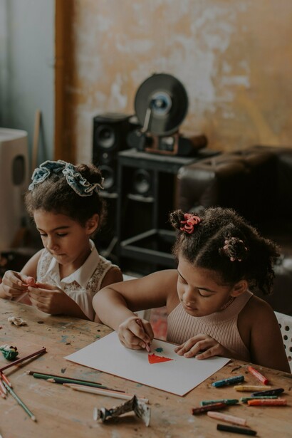 Children sat drawing at a table