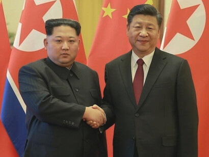 North Korean leader Kim Jong-un shakes hands with Chinese President Xi Jinping during an unofficial visit to Beijing, in this undated photo released by North Korea's Korean Central News Agency (KCNA) in Pyongyang