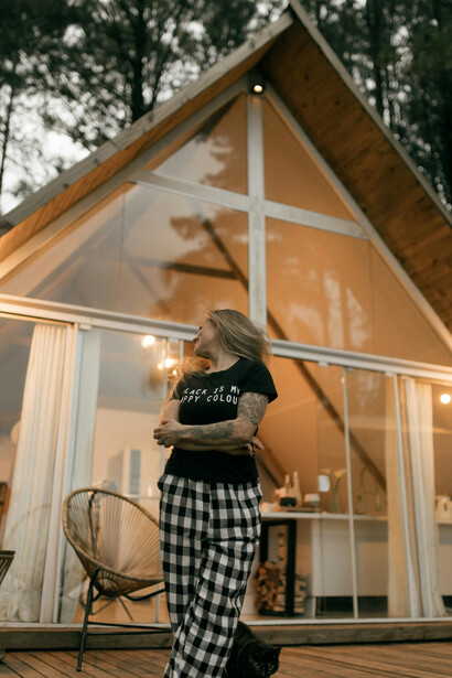A peaceful wooden A-frame cabin nestled in the mountains, capturing the essence of offline travel, silent retreats, and slow living in nature