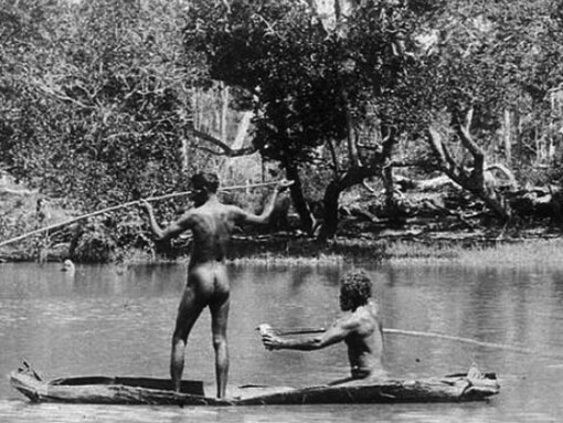 Two Aboriginal men spearing fish from a bark canoe, Australia. Photograph by Thomas Dick, c. 1905