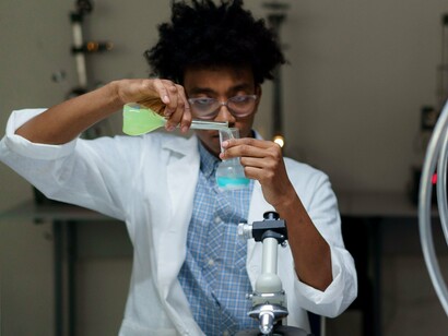 A Black researcher exploring new scientific possibilities, symbolising the future shaped by knowledge, perseverance, and innovation