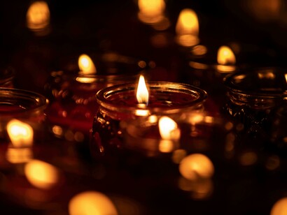 Warm candlelight flickers gently, guiding the path through the darkness