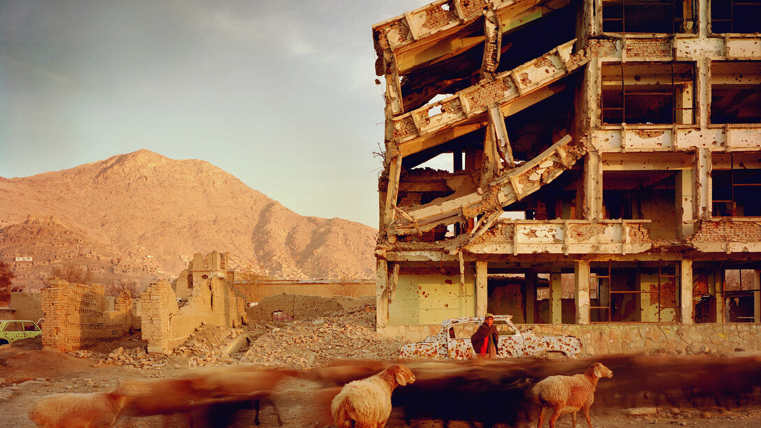 Simon Norfolk, Bullet-scarred apartment building and shops in the Karte Char district of Kabul. This area saw fighting between Hikmetyar and Rabbani and then between Rabbani and the Hazaras, 2003, © Simon Norfolk
