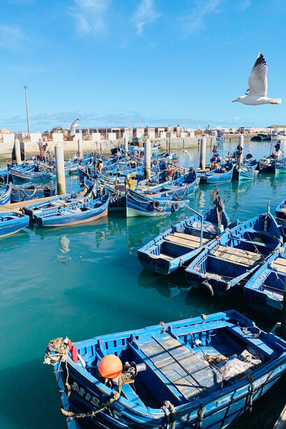 Essaouira's fishing port, with its distinctive blue fishing boats, captures the essence of Morocco's cultural tapestry, a harmonious blend of traditions that celebrates diversity and mutual respect