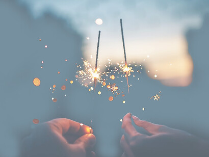 Dazzling moments, shallow focus photography of two people holding firecrackers