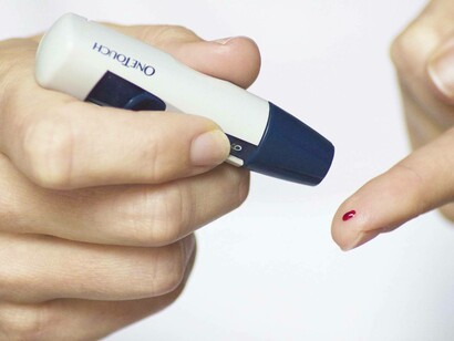 Getting ready as a diabetic to test the trace amounts of blood sugar to determine the next course of action