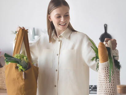 A woman opts for eco-friendly fabric bags instead of traditional shopping bags