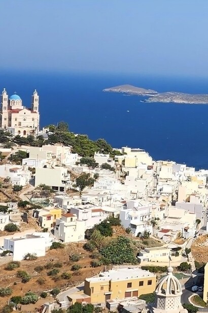 A panoramic view of Ermoupoli, Syros, overlooking the Aegean Sea, representing the island's understated beauty beyond Greece's busiest tourist destinations