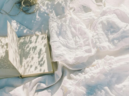 Sunlight on fabrics and paper mirrors the way travel impressions linger in memory