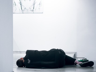 A boy laying on the floor, suffering from anxiety