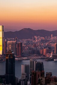 Hong Kong’s towering skyline in the evening light, reflecting the vibrant rhythm of a city that never stops moving