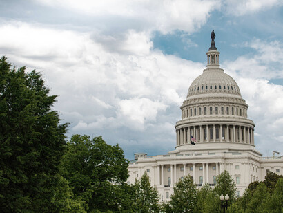 The U.S. Capitol building under white clouds and a bright blue sky in Washington, D.C.