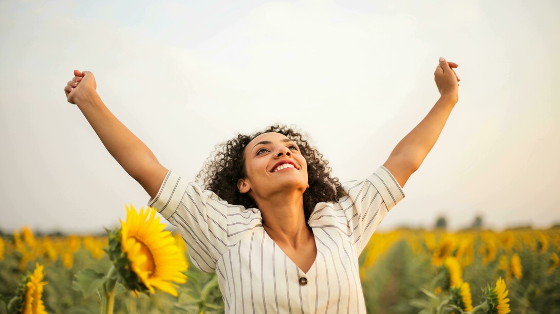 Mulher expressa sua felicidade na natureza