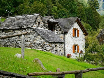 A traditional house constructed from earthy, locally grounded materials, symbolising the relationship between traditional building practices and their natural surroundings