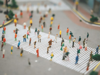 Image of miniature people walking on a striped path