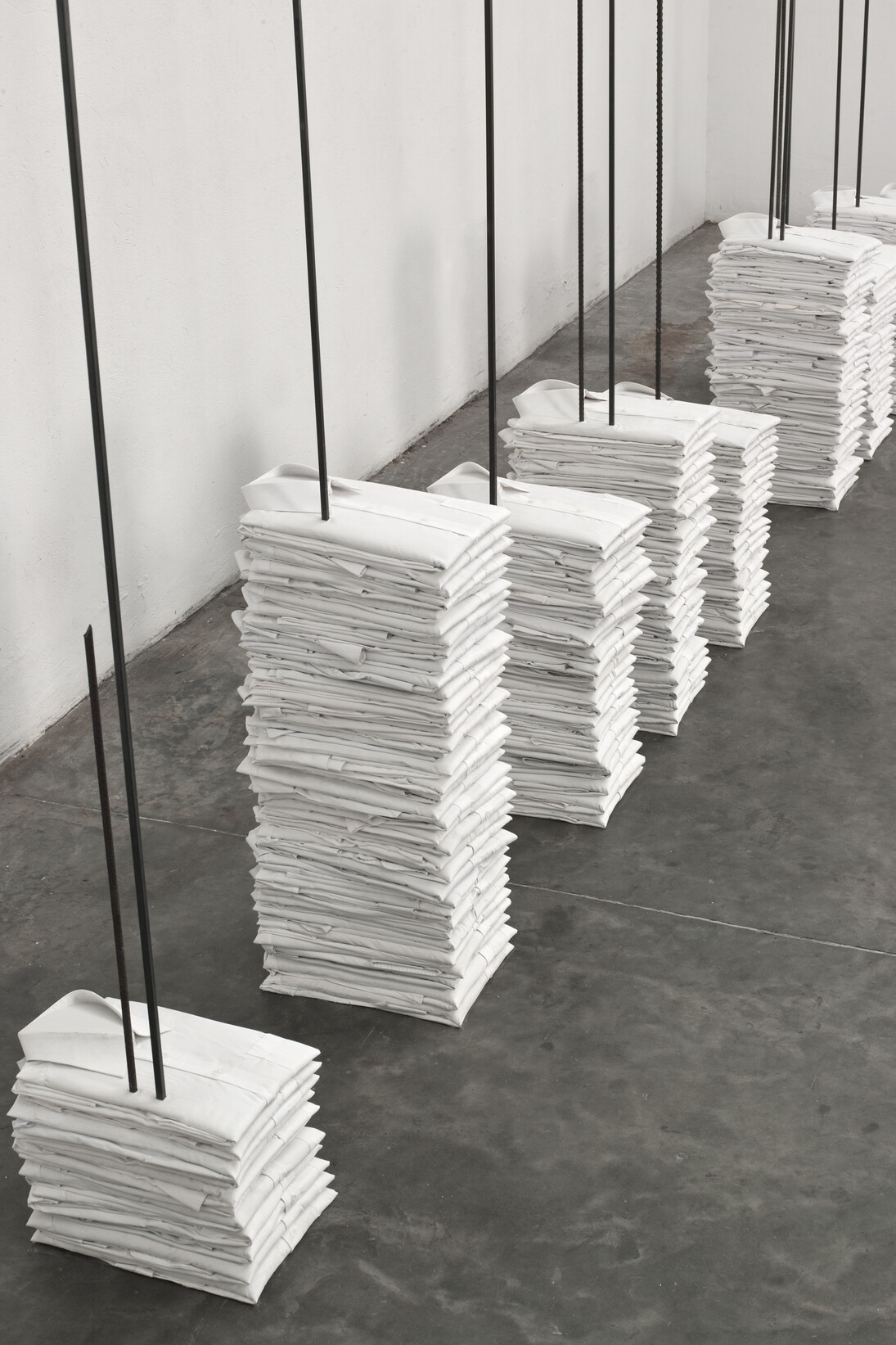 Doris Salcedo, Untitled (camisas), 2013, Cloth shirts, metal rebars, and plaster in 11 parts. Photo: Oscar Monsalve Pino. Courtesy Alexander and Bonin, New York