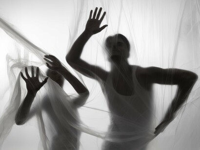 Veiled silhouettes moving spookily, symbolising how unspoken nightmares often lasts longer
