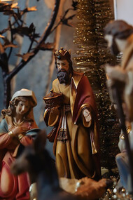 Tiny figurines of Jesus and Mary grace the Christmas setting, reminding us of the sacred origins of the holiday