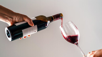 A person gracefully pouring wine into another's hand, capturing the essence of hospitality and shared enjoyment