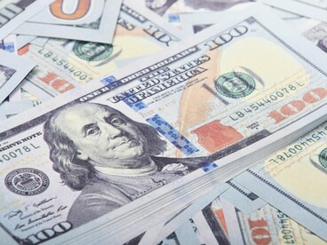 A scatter of U.S. currency on a flat surface, representing the re-entry of global capital into African innovation