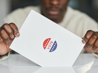 A young man exercising his right to vote, a testament to the power of democracy at a time when many young people choose disengagement leading to a weakening of our political system
