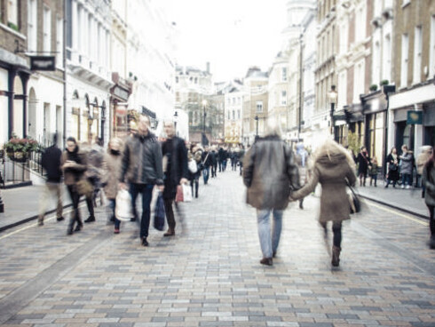 Shoppers stroll down the High Street in a typical UK town