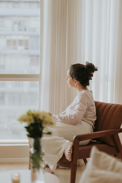 A woman journaling in a cozy apartment, creating space for inner healing and quiet relaxation