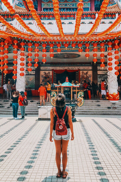 A woman facing the Petronas Twin Towers, Kuala Lumpur, Malaysia