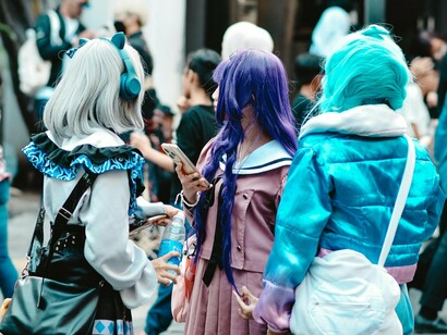 Gen Z fans in vibrant cosplay, mirroring the visual appeal that drives their love for anime