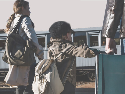 A family stands together with luggage, fleeing Ukraine amid tumultuous circumstances