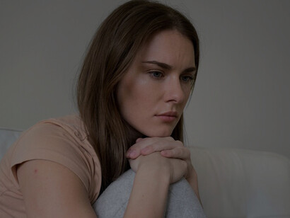A woman confronts anxiety and depression at home, showcasing her resilience and strength in overcoming challenges