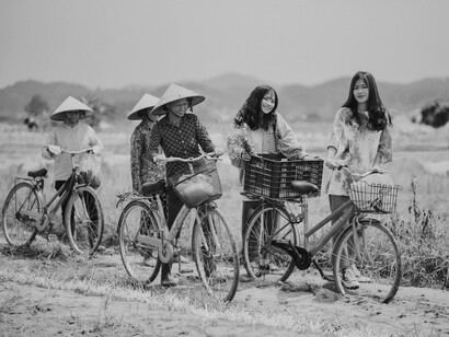 Asian females riding bikes in the countryside