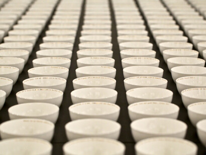 Claire Twomey, Everyman’s Dream, 2013, bone china and 18 carat gold text. Installation view, Legacy at Crafts Council fair Collect at Saatchi Gallery © Sophie Mutevelian