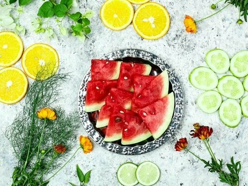 A colorful arrangement of fruits and vegetables rich in water and nutrients, representing lifestyle factors that may support healthy skin aging