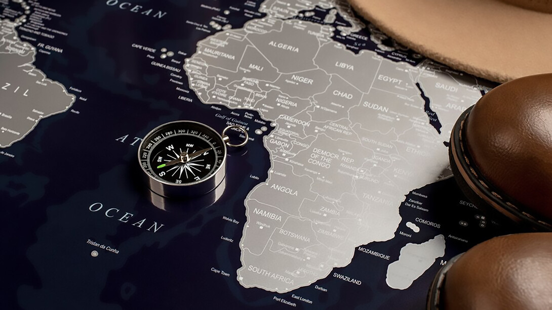 Africa continent map with a compass and shoes, symbolizing navigation and exploration possibilities across diverse landscapes