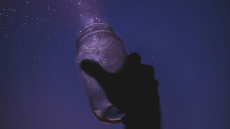 A person releasing stardust onto the night sky