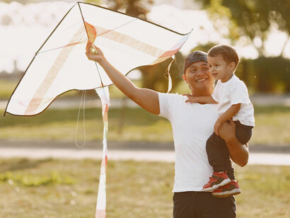 Father and son bond and share a memorable experience together through playing with a kite