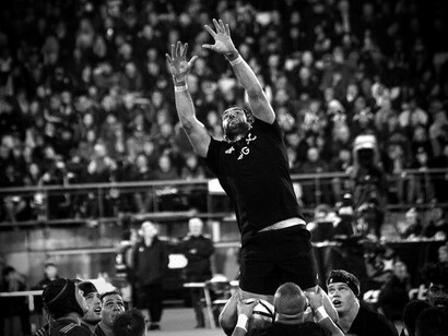 A New Zealand rugby team member jumping to snatch the ball away from the oppostion
