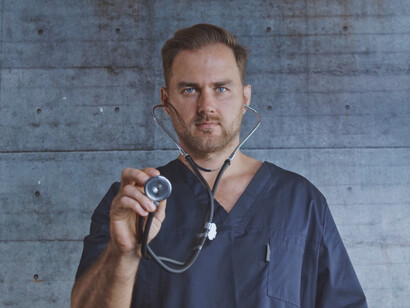 As he pauses to gather his thoughts, this doctor's expression speaks volumes about the isolation and suffering faced by those in the medical field