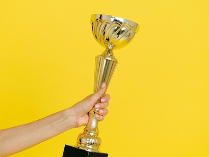 Person holding a trophy showing success