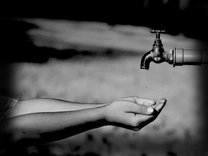 Hand looking for water from a tap. Over two billion people live in countries where water supply is inadequate