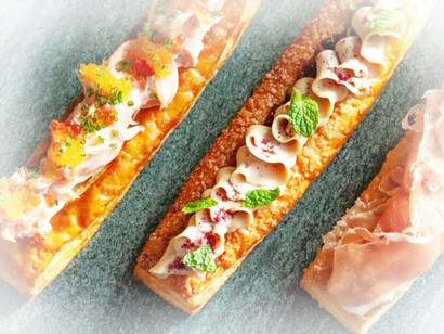R-L: Salmon Danish with confit salmon, smoked trout roe, herb cream cheese, and lemon olive oil; F gras ganache, pistachio, and sour cherry and hibiscus jam Danish; and Jamon serrano and raclette cheese Danish