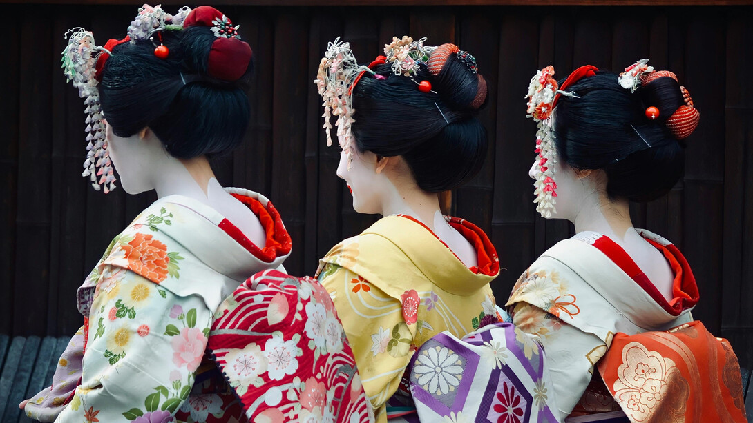 Women dressed in traditional Japanese attire: elegant kimonos with vibrant colors and intricate floral patterns are present in Japan's streets even nowadays