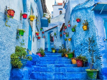 A winding blue alleyway through Tangier in Morocco, reflecting the journey toward self-discovery beyond life's familiar circles