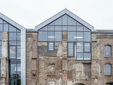 An aged brick warehouse transformed with contemporary interventions, presenting the reinvention of industrial spaces