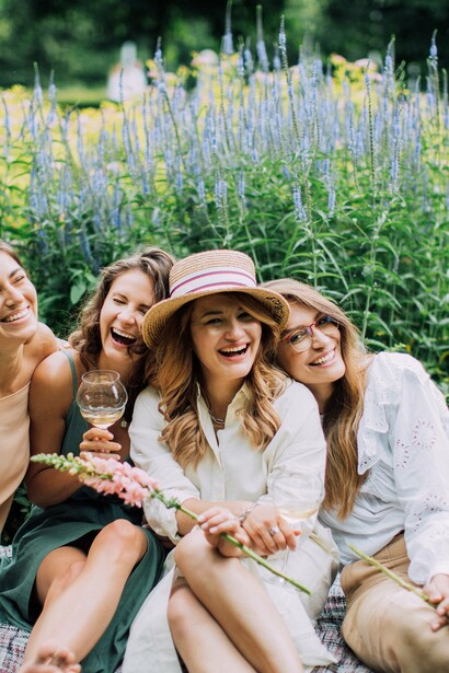 Friends enjoying white wine and posing for a group photo
